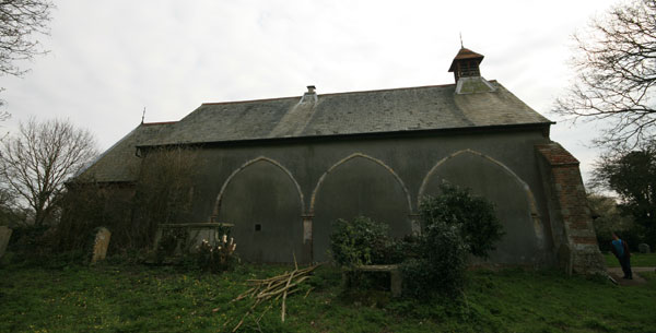 Side view of the church. The arches are all that remains of the 12th century priory.
