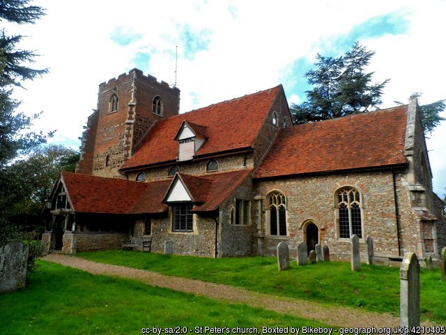 A photograph of St Peter's church, a small church made from flint, stone and brick.